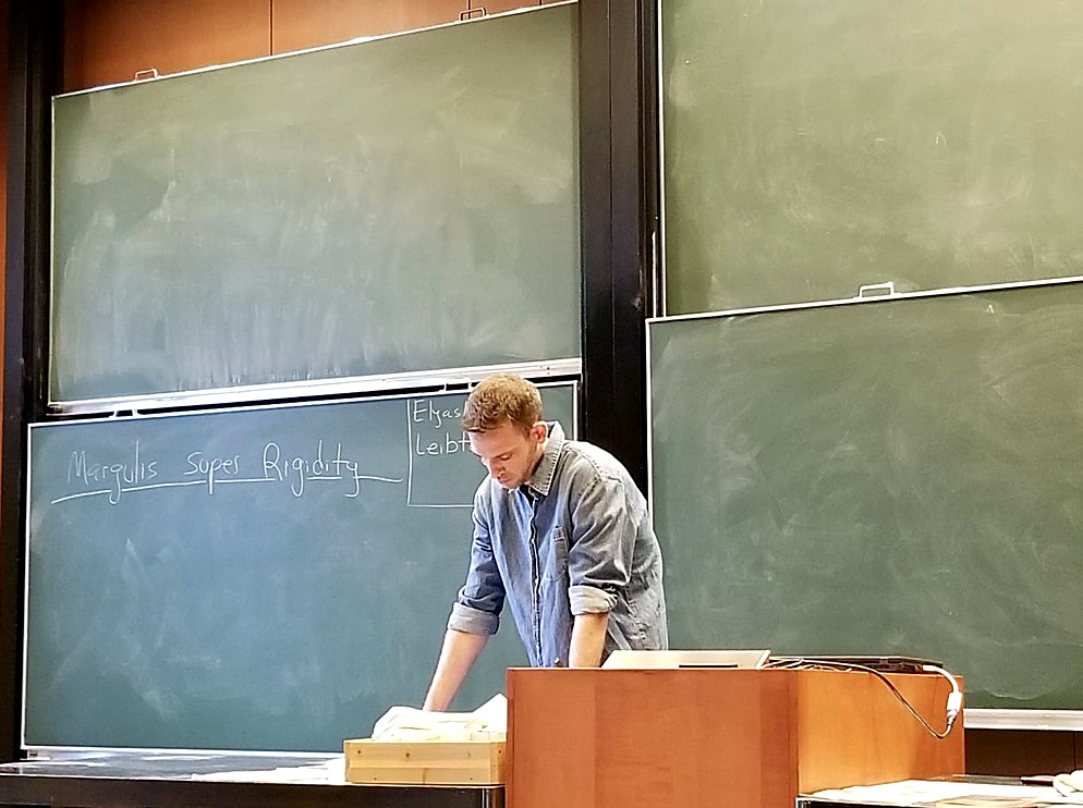 Elyasheev Leibtag preparing a lecture on Margulis superrigidity at a chalkboard